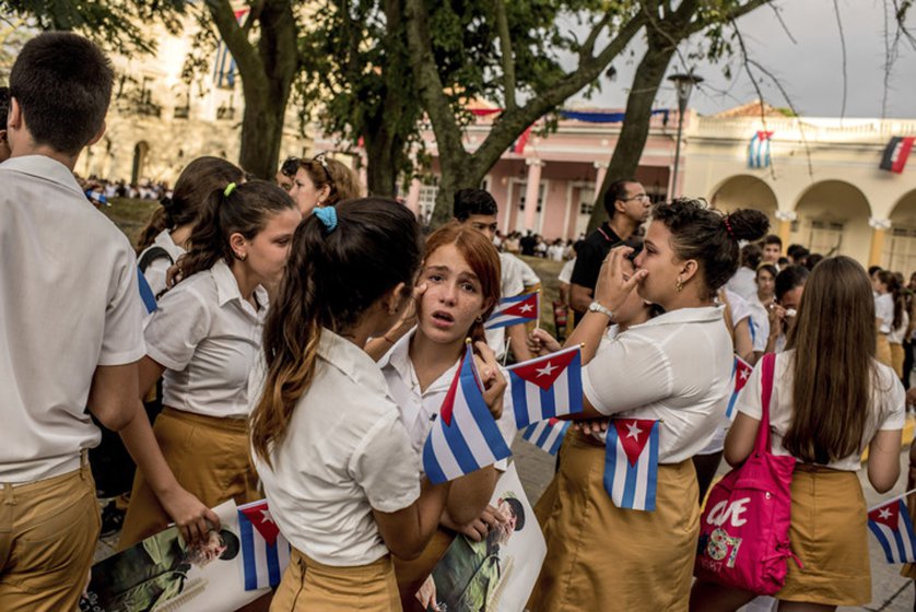 Children cry as a caravan carrying Fidel Castro's ashes passes through Santa Clara, Cuba.