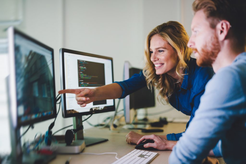Programmers cooperating at IT company developing apps