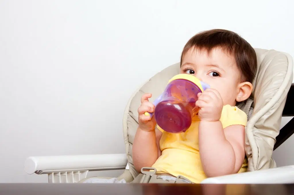 Baby infant drinking from sippy cup