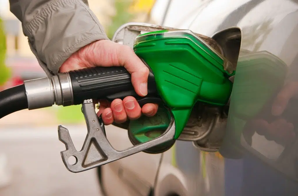 male hand refilling the car with fuel on a filling station