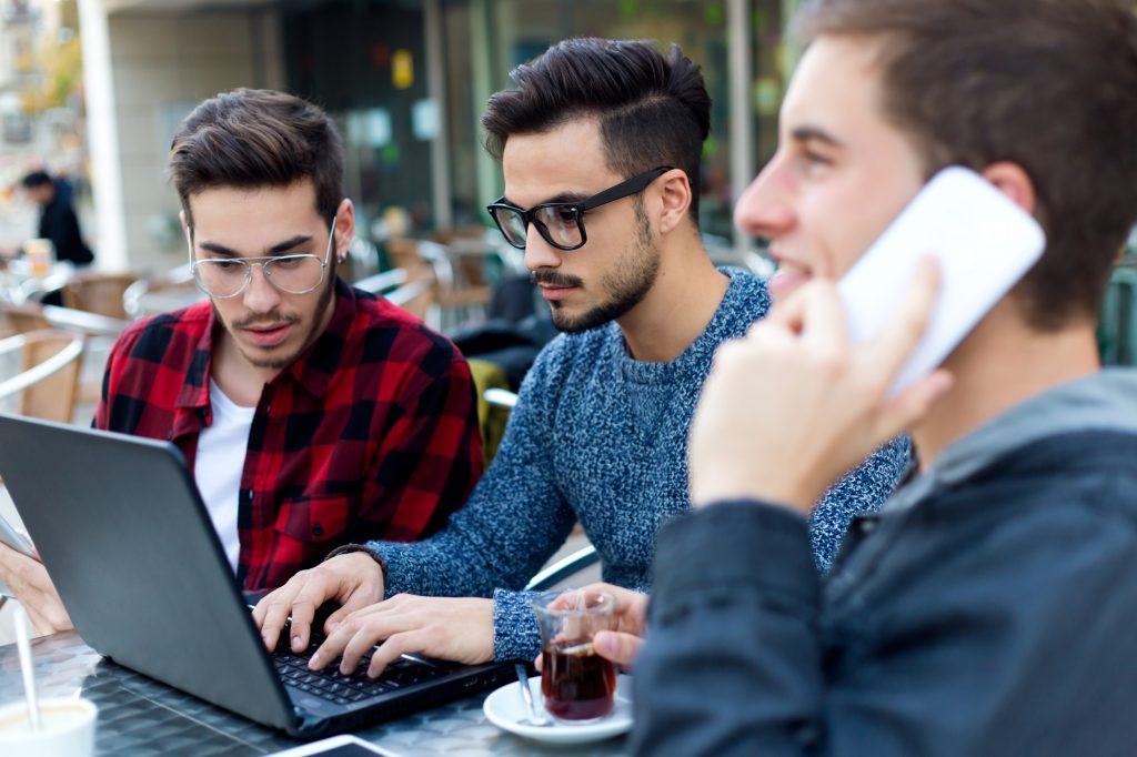 Outdoor portrait of young entrepreneurs working at coffee bar.