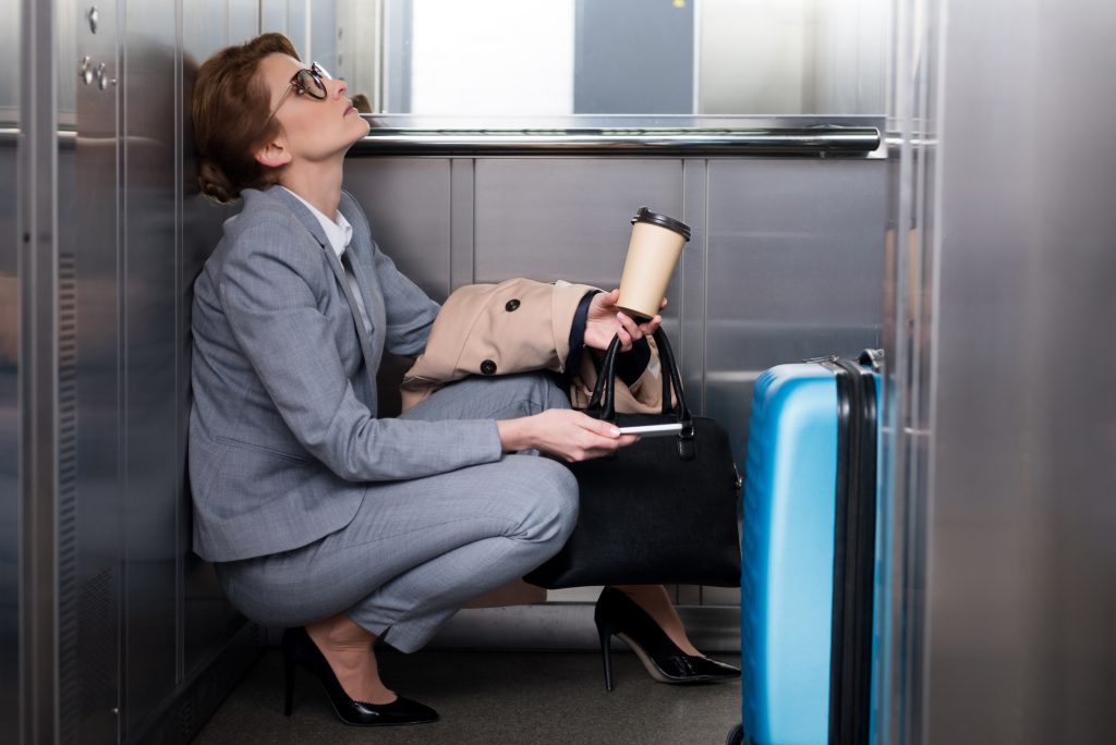A woman is stuck in an elevator