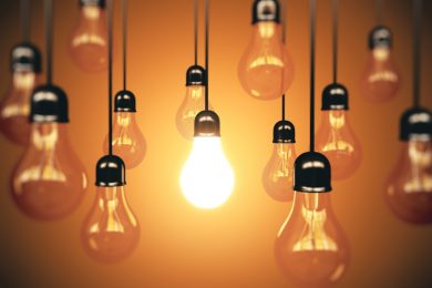 Many light bulbs and one glows
