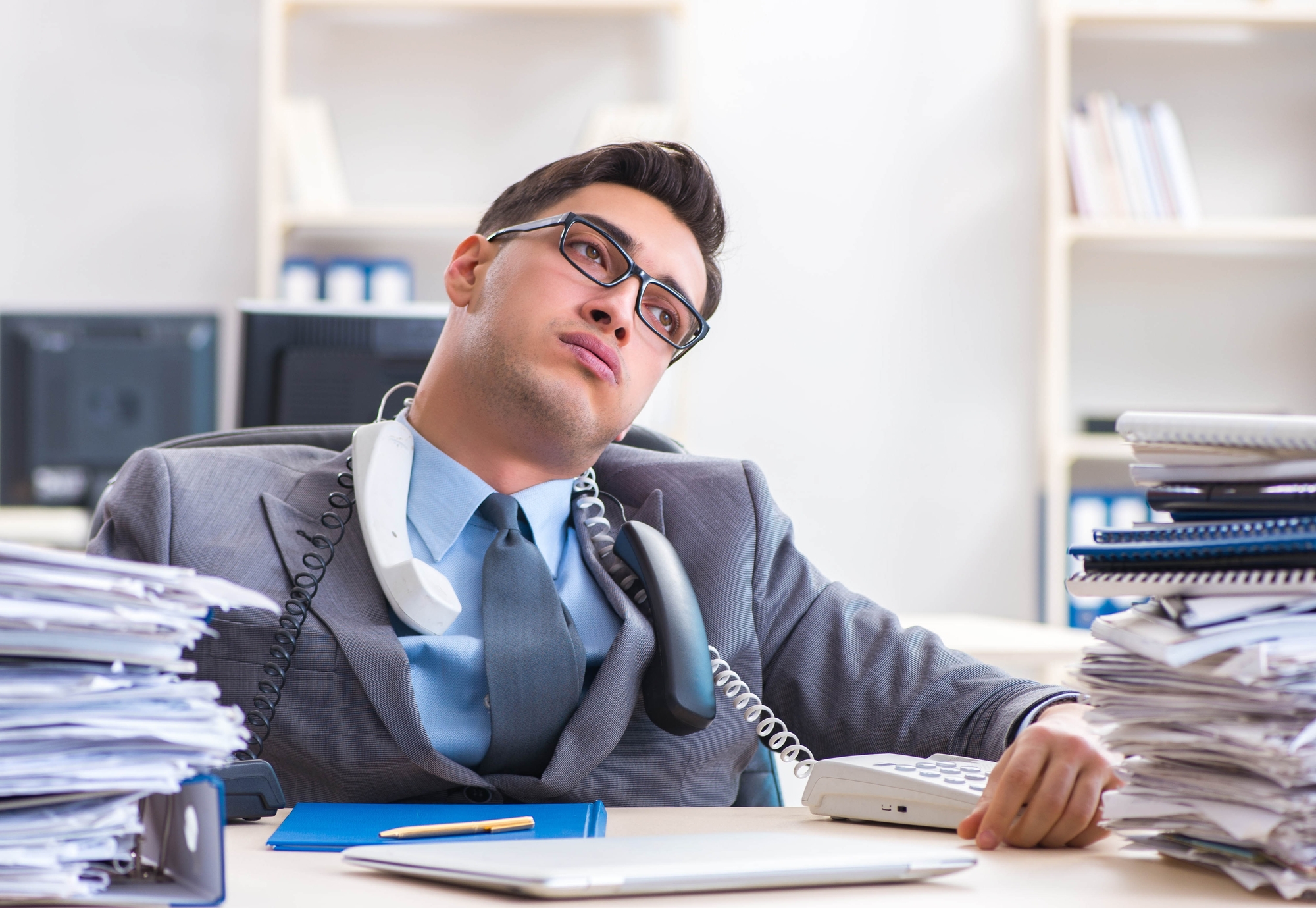 Desperate sad employee tired at his desk in call center