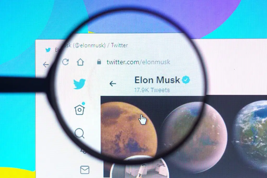 May 22, 2022, Brazil. In this photo illustration Elon Musk official Twitter profile seen on a computer screen through a magnifying glass.