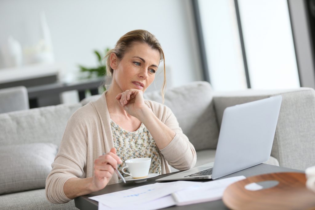 Middle-aged woman working from home on laptop