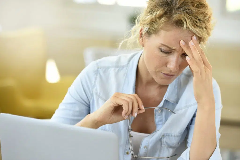 Woman at work suffering painful headache