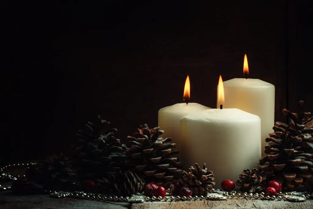 Christmas or New Year's composition with burning white candles,