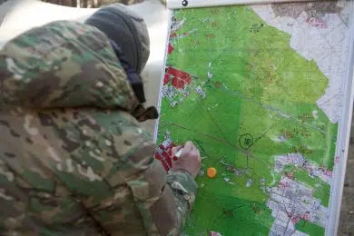 Ukrainian soldier works with a map