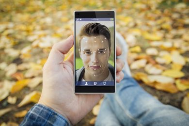 man in the park face id smartphone