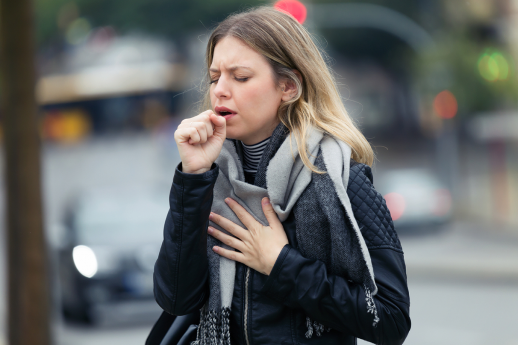 Young woman coughing attack
