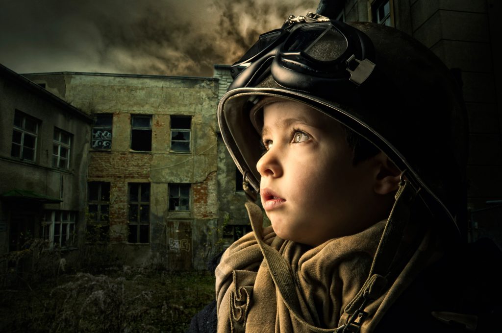 Young boy alone in a war zone
