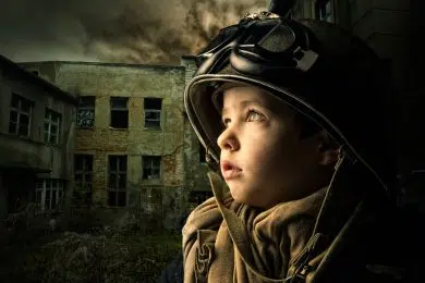 Young boy alone  in a war zone