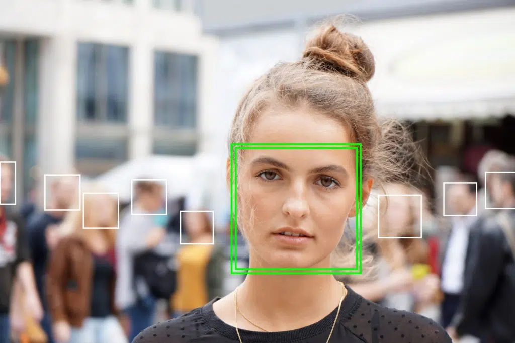 young woman picked out by face detection or facial recognition software