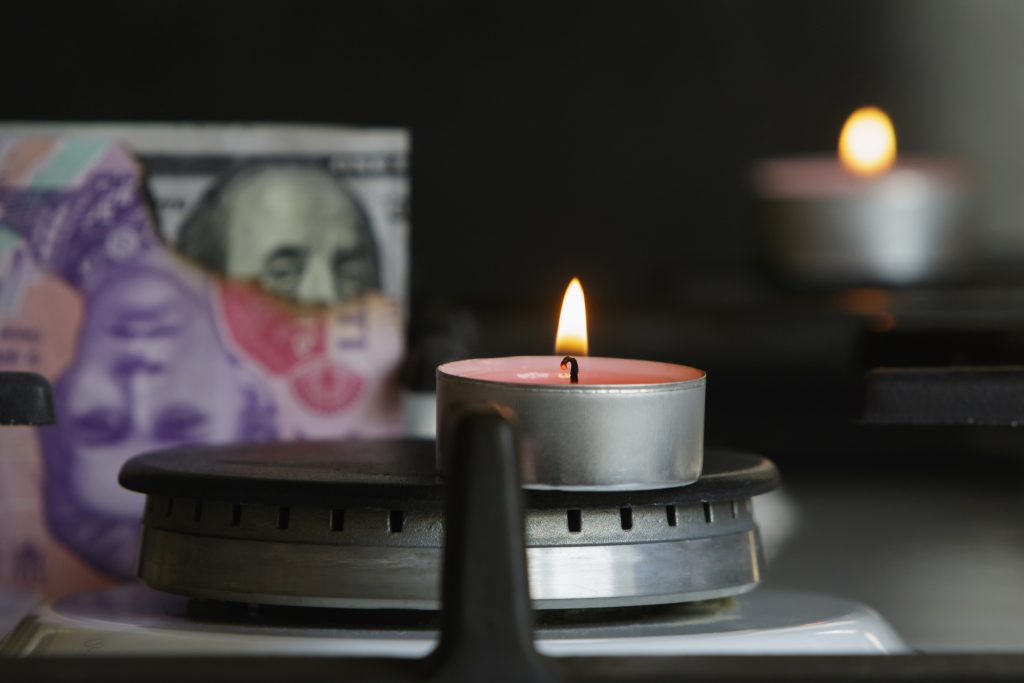 Gas burner with fire and currency.