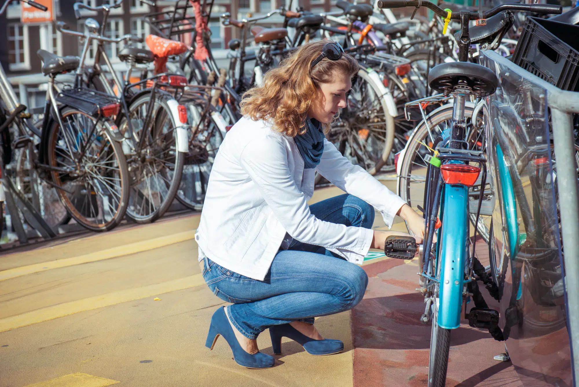 Woman unlocking the bicycle