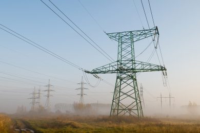 High-voltage power line against landscape