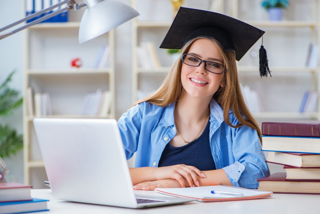 Young teenage female student preparing for exams at home
