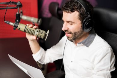 Talk show radio host talking into microphone