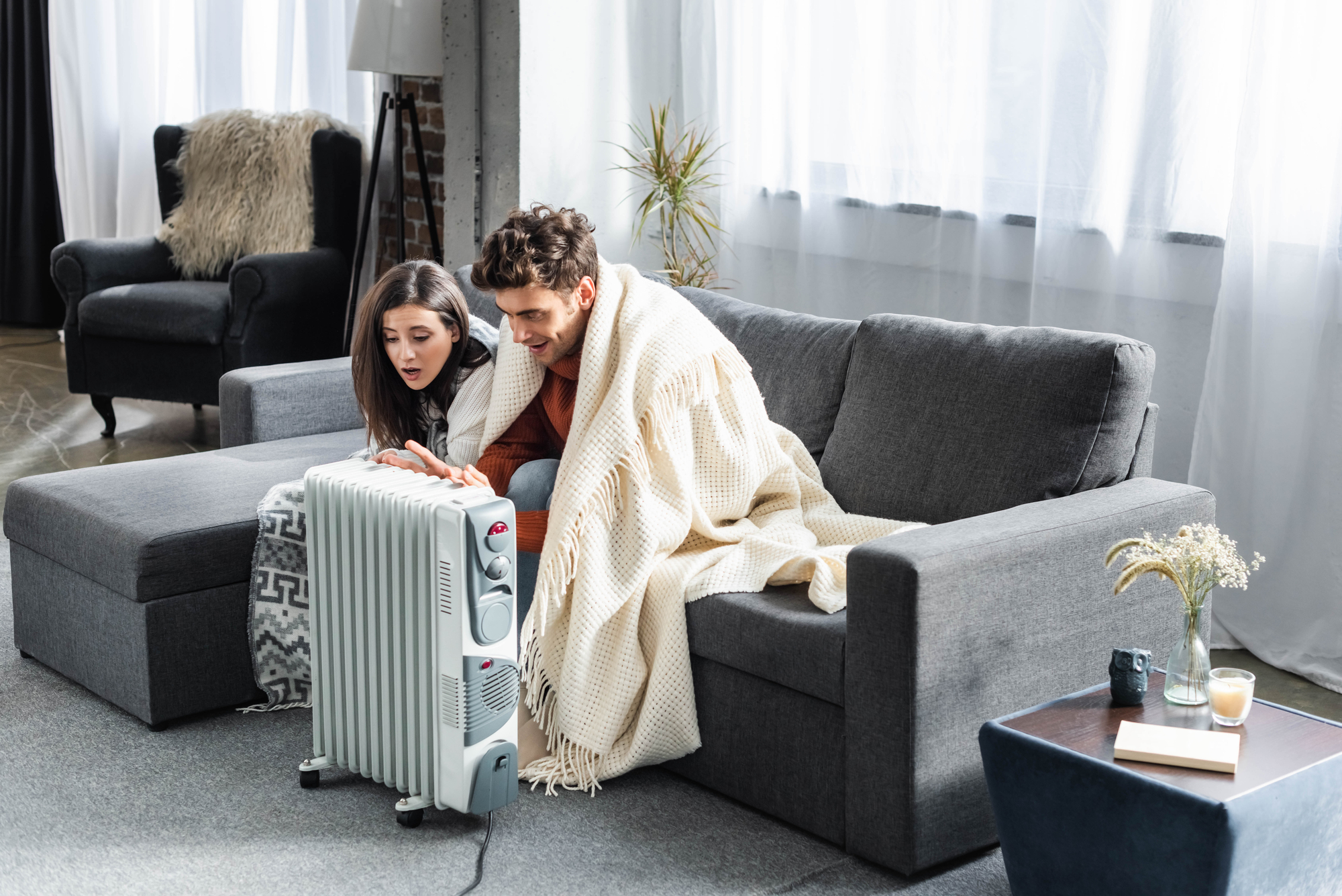 The couple warms up from an electric heater