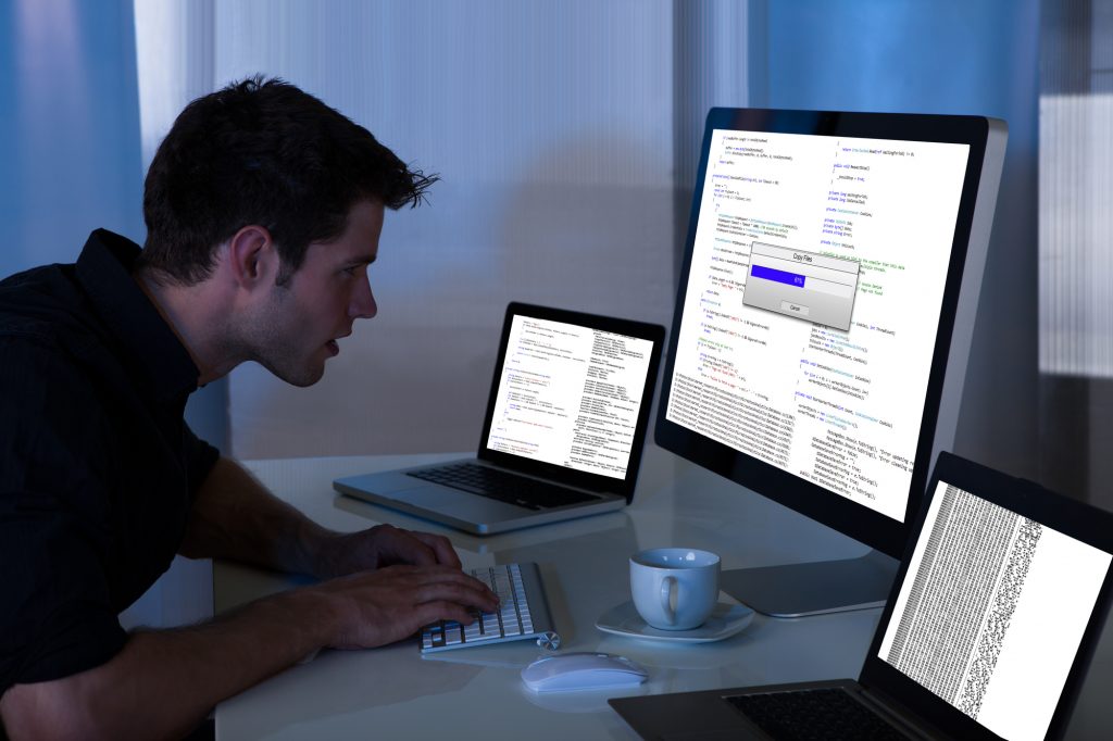 Man Working With Computer And Laptop