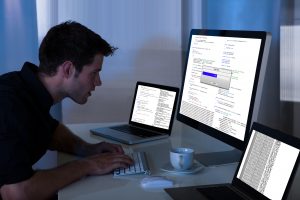 Man Working With Computer And Laptop