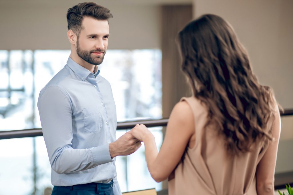 Man and woman meeting in the restaurant and looking excited