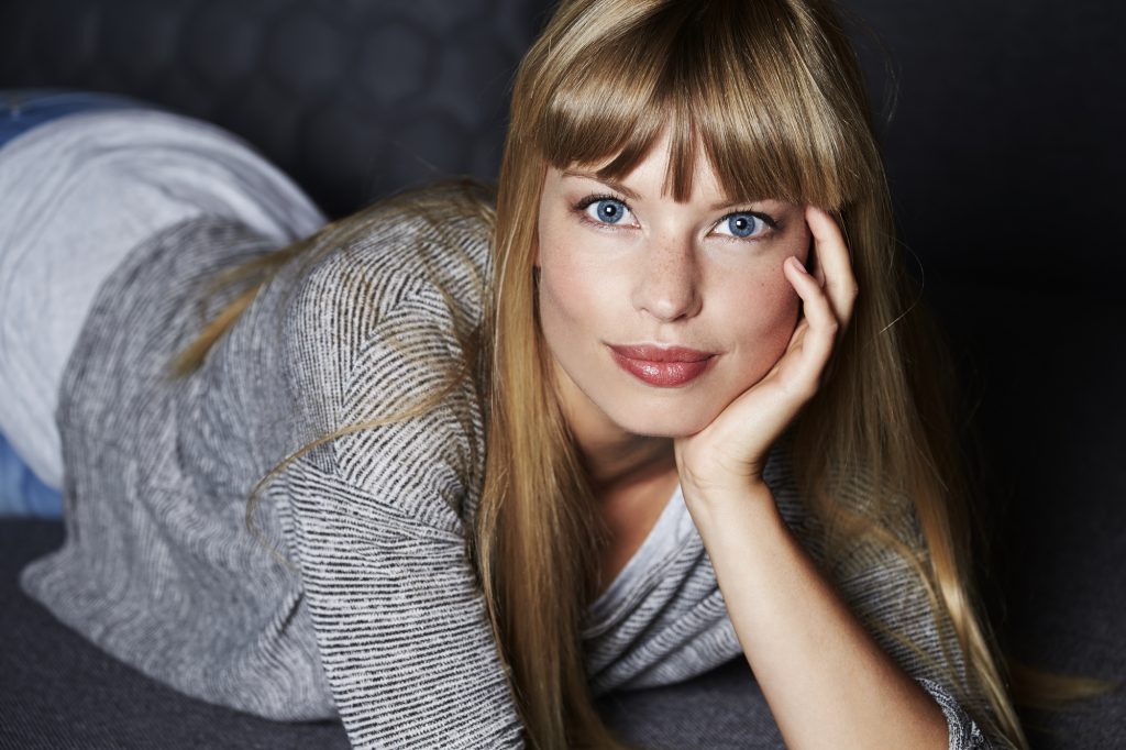 Gorgeous young woman lying on sofa