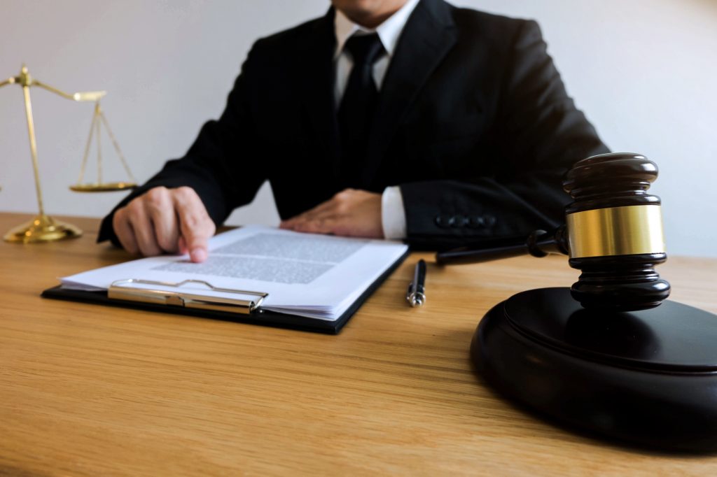 Lawyer working with contract papers on the table in office. cons