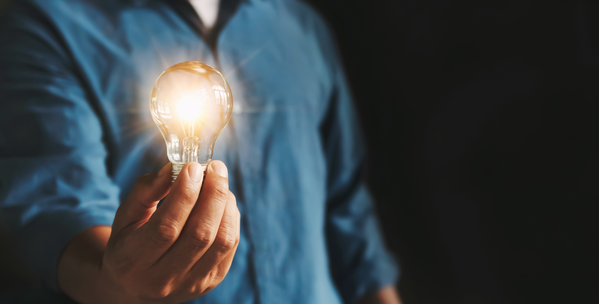 businessman hand holding lightbulb. idea Alternative energy conc