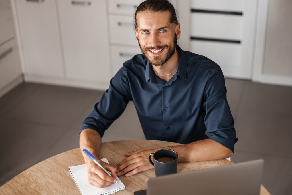 A handsome young man takes notes