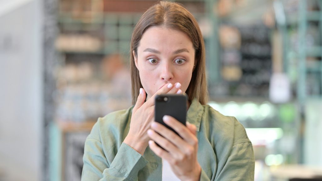 Portrait of Upset Woman having Loss on Smartphone