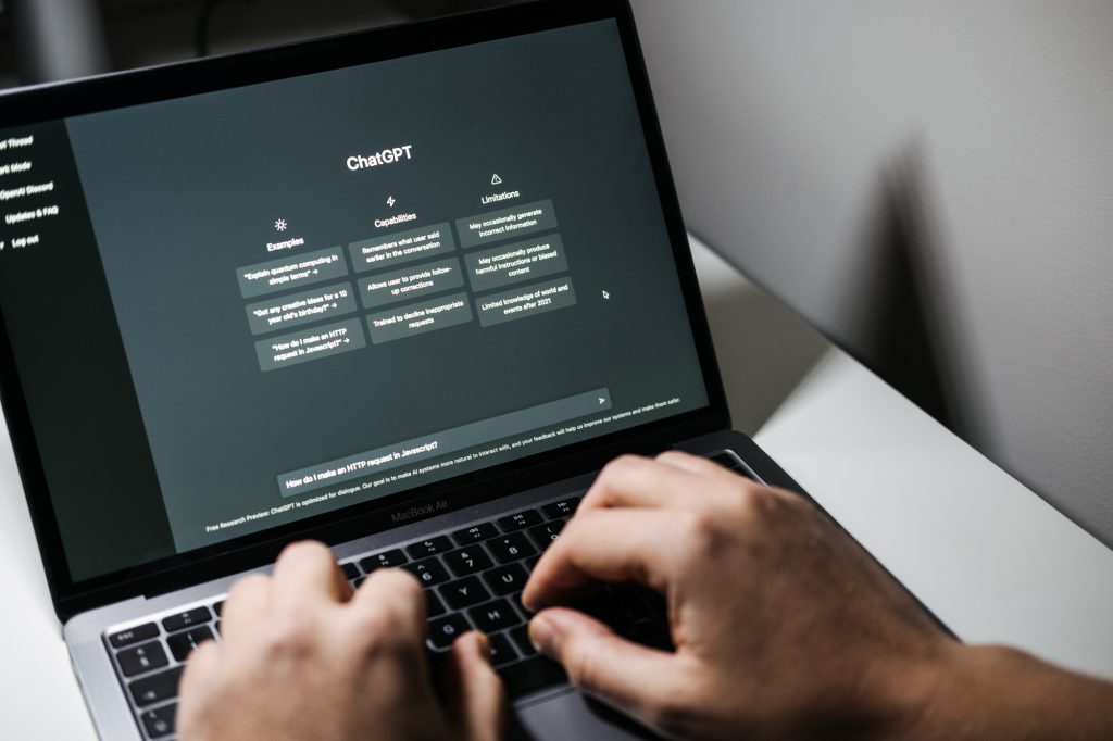 Screen with ChatGPT chat with AI or artificial intelligence. Man search for information using artificial intelligence chatbot developed by OpenAI. Warsaw, Poland - December 02, 2022