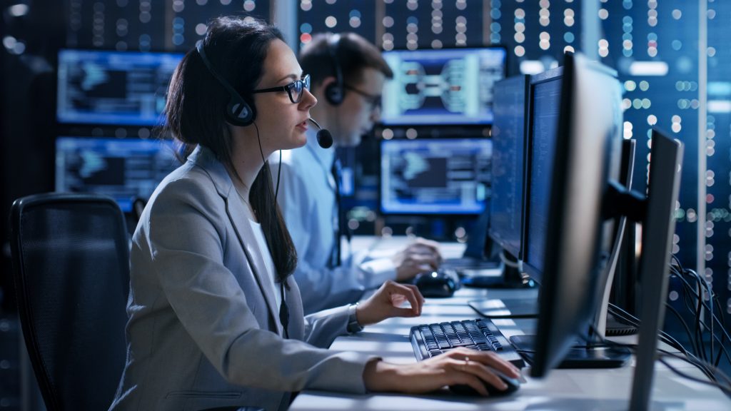 Female working in a Technical Support Team Gives Instructions wi