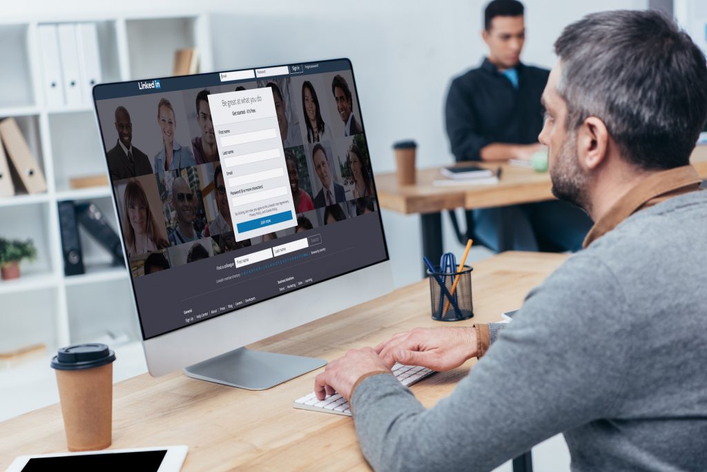 A man fills out a LinkedIn profile