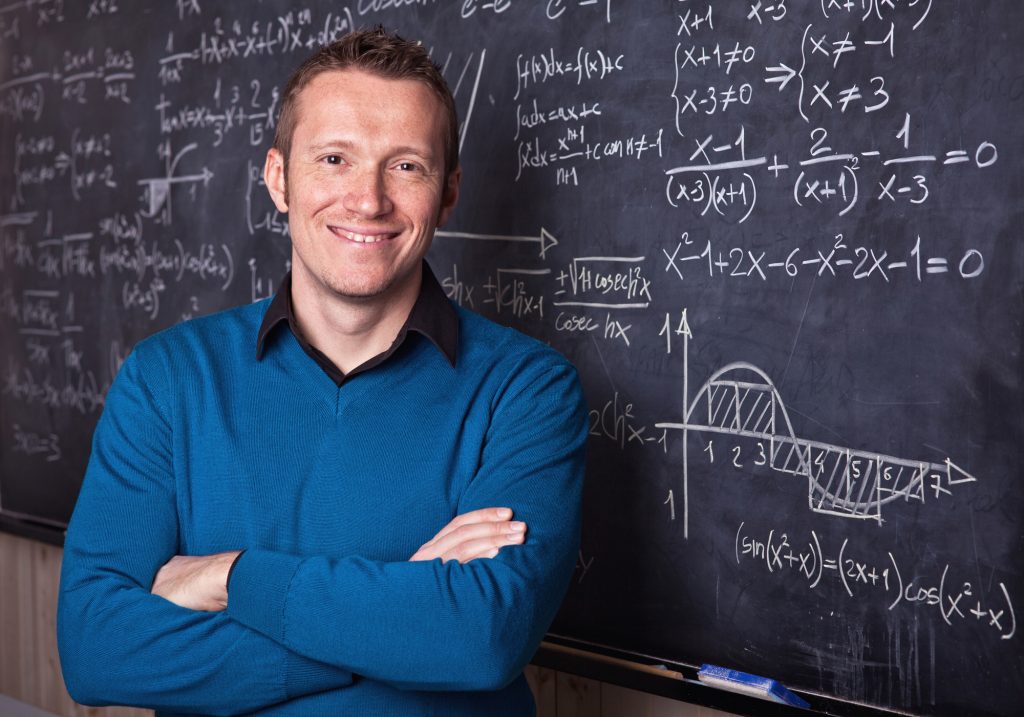 young caucasian teacher portrait with blackboard background
