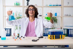 The funny male chemist working in the lab