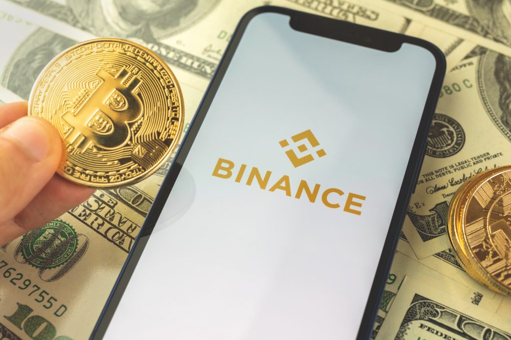Kharkov, Ukraine - May 3, 2021: Binance buy and sell crypto currency app on the screen with bitcoin background