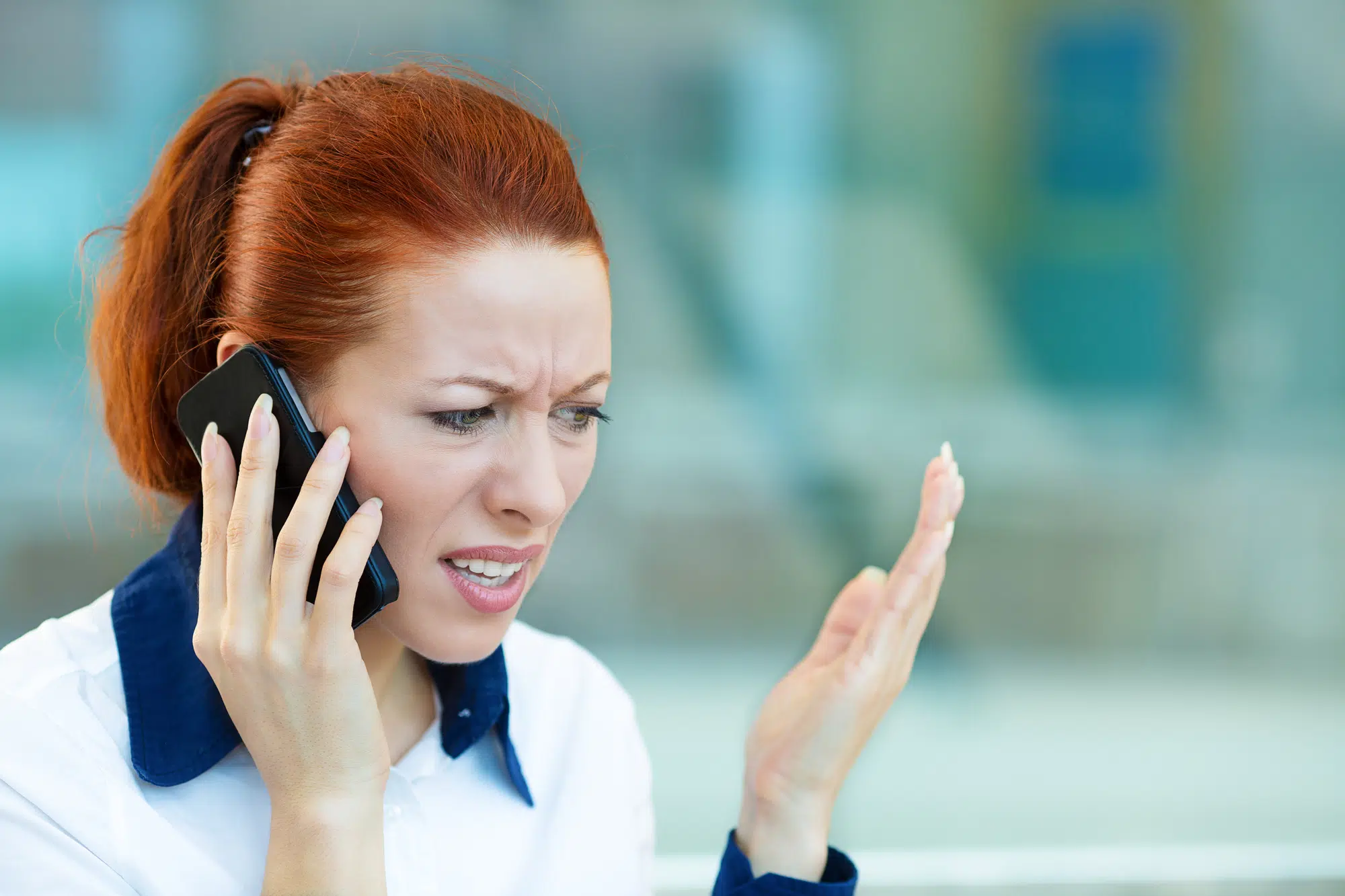 Upset woman having unpleasant conversation on a phone