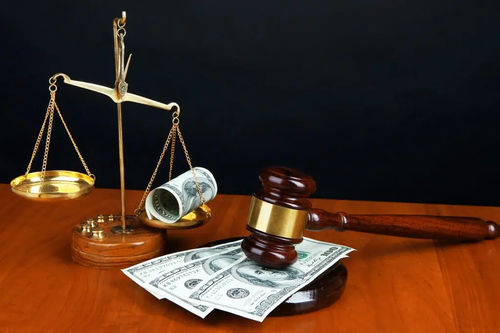 Gavel,scales and money on table on black background