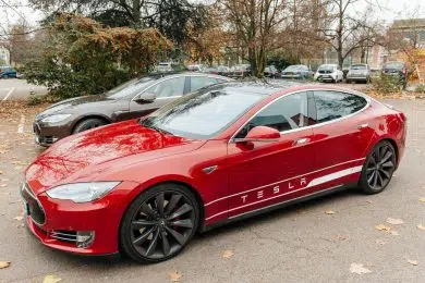 PARIS, FRANCE - NOVEMBER 29: Row of New Tesla Model S cars in front of showroom in Paris, France. Tesla is an American company that designs, manufactures, and sells electric cars