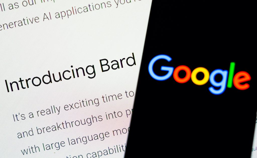 February 9, 2023, Brazil. In this photo illustration, the Google logo is displayed on a smartphone screen, in the background, the page of the new artificial intelligence (AI) tool called Bard