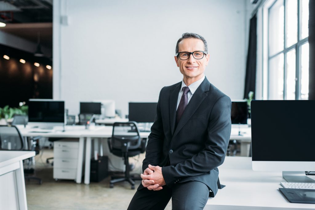 CEO poses against the background of a beautiful office space