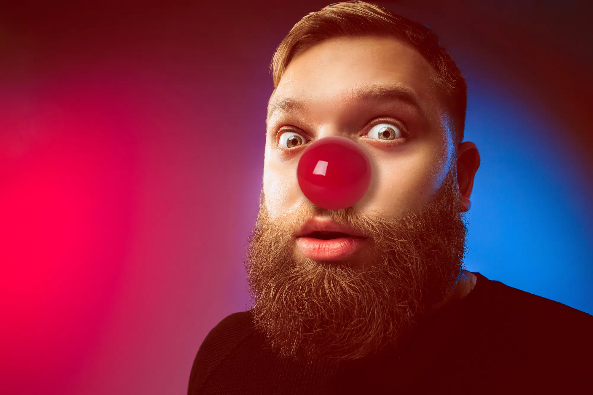 The happy surprised and smiling man on red nose day. The clown, fun, party, celebration, funny, joy, holiday, humor concept