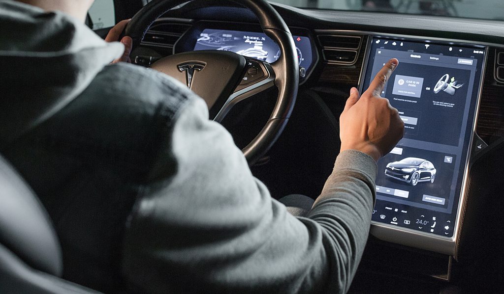 Inside Vew of Tesla Electric Vehicle. Sreering Wheel and Displays. Driver Tapps Control Displays and Inbuilted Tablet of New Generation Electro-Hybrid Car. Kyiv, Ukraine, F-Drive showroom 13 of february 2018.