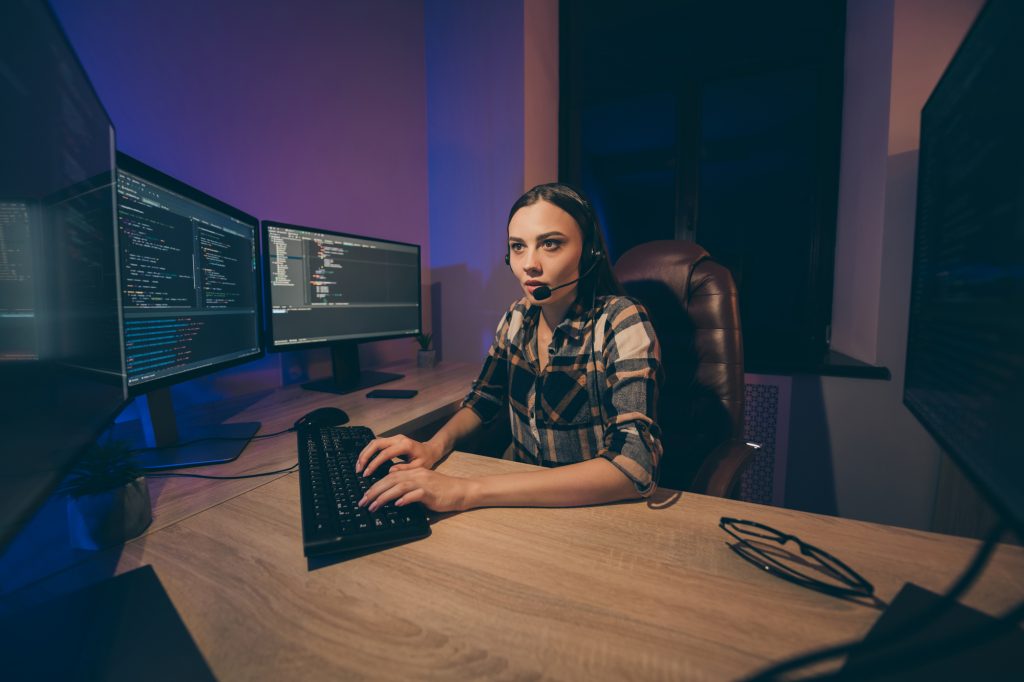 Photo of professional focused concentrated coder modifying apps, supporting artificial intelligence revealing javascript code