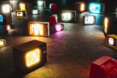 vintage televisions turned on the floor. Nobody around. 3d render. concept of mass media and tv addiction.