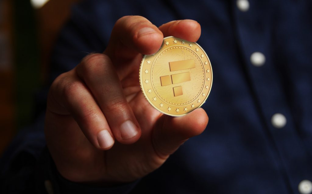 FTX NFT Bahamas, peer to peer, cryptocurrency platform symbol golden coin in hand abstract concept.