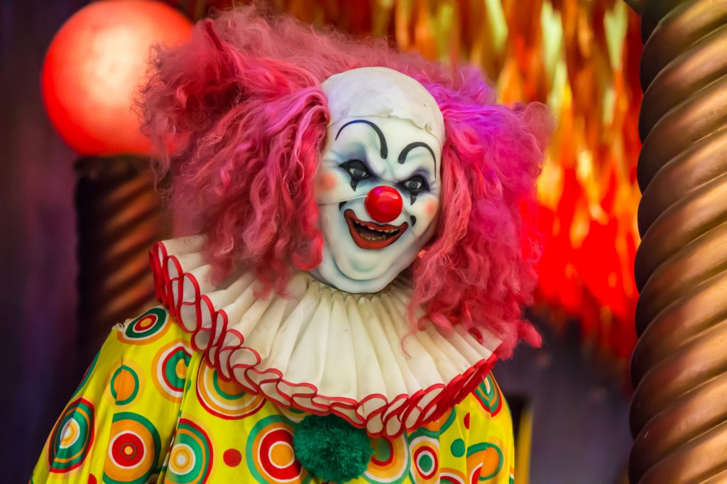 Scary clown robot in clown mask.