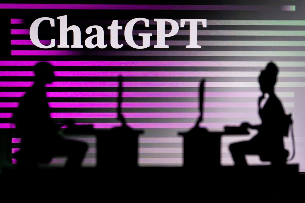 UK, LONDON. JANUARY 30, 2023: ChatGPT. Innovating the Future: Silhouette of Two Software Developers and the Company's Logo in the Background